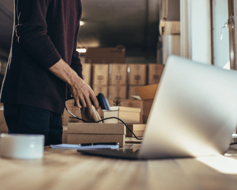 Worker scanning product in warehouse